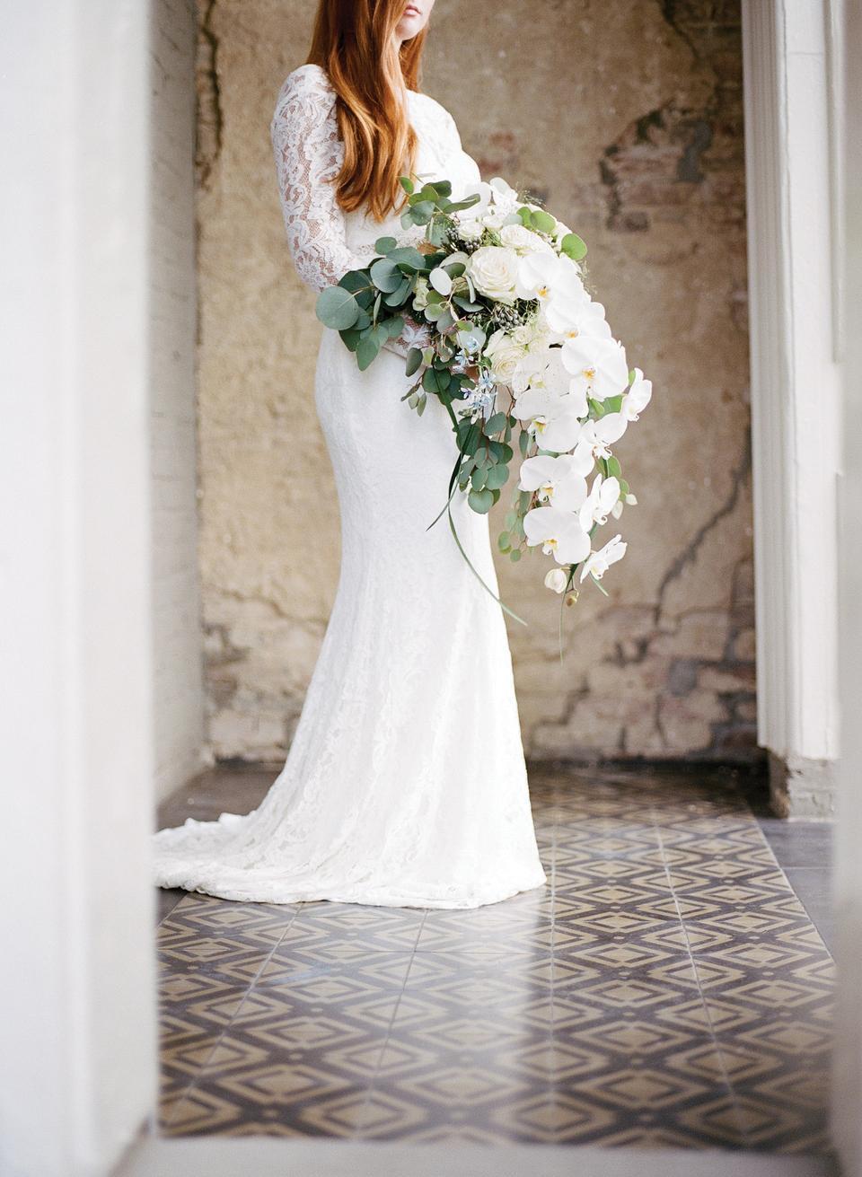 cascading wedding bouquet with white phalaenopsis orchid, eucalyptus and roses