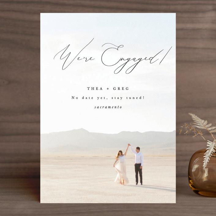 Personalized photo background with 'We're engaged!' in calligraphy
